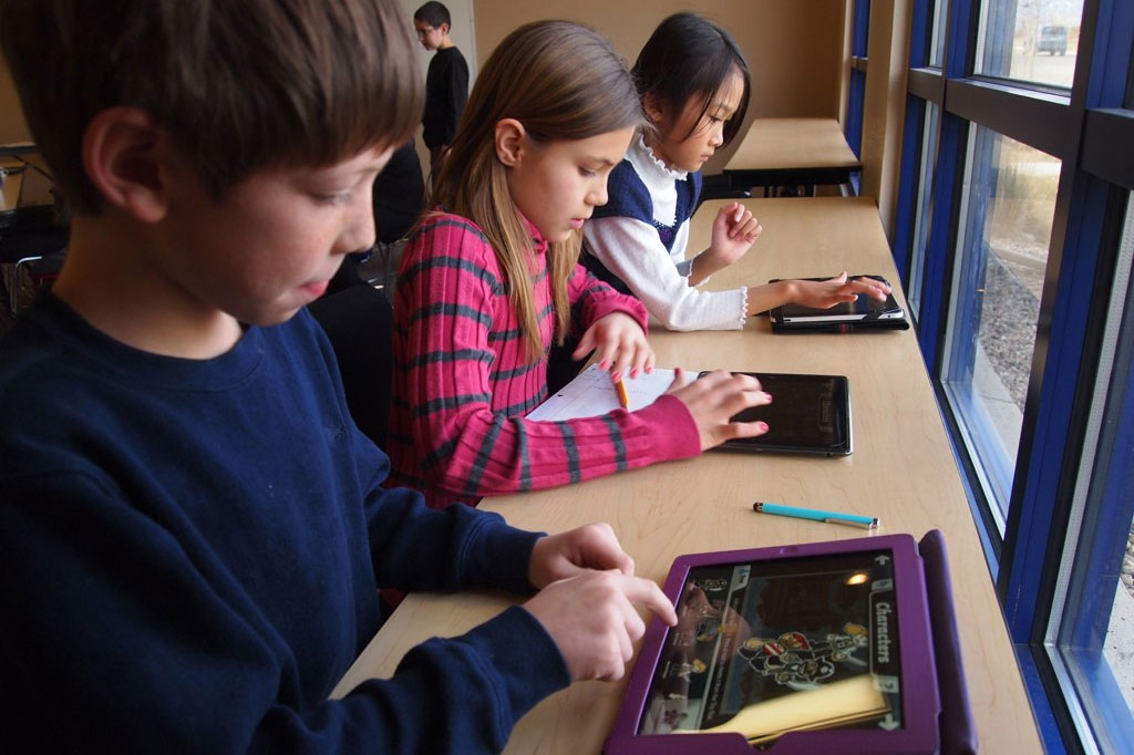 Elementary students using iPads for school work