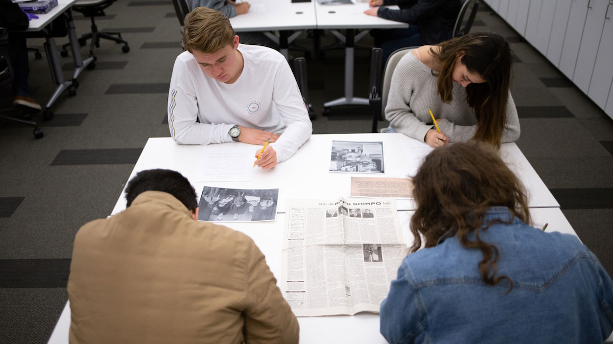 Several students doing focussing on work around a table