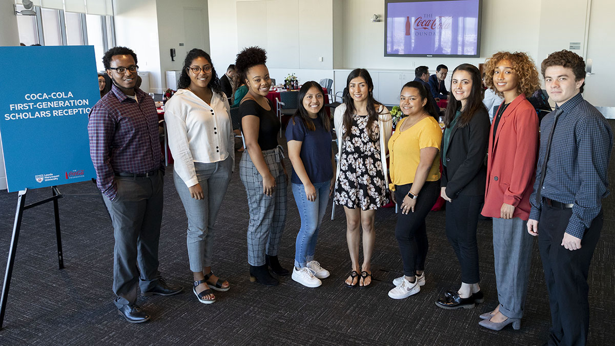 A group of students in professional attire at the Coca-Cola First-Generation Scholars Reception