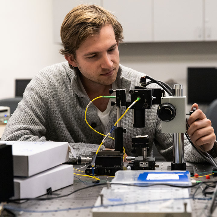 An student using a complex microscope