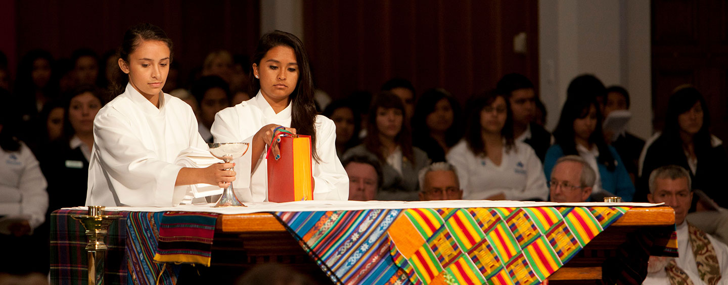 Two students participating in a religious event in Sacred Heart Chapel