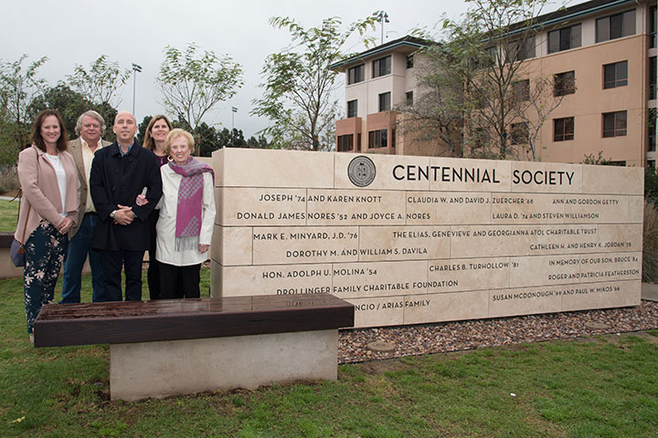 Several members of the Centennial Society standing next to the monument