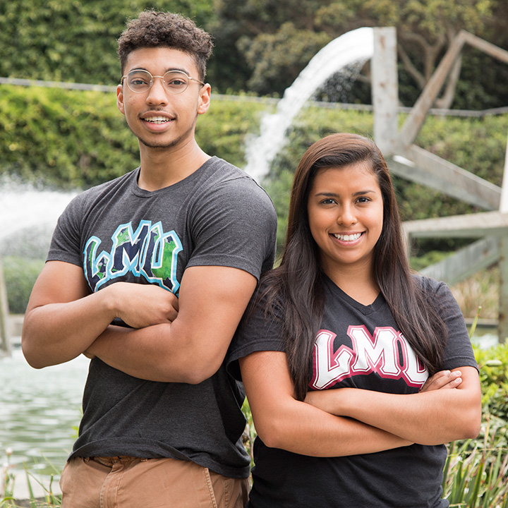 Two students standing near Roski Fountain