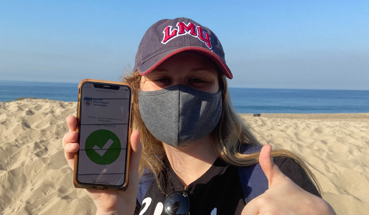 An LMU student does field work at the beach