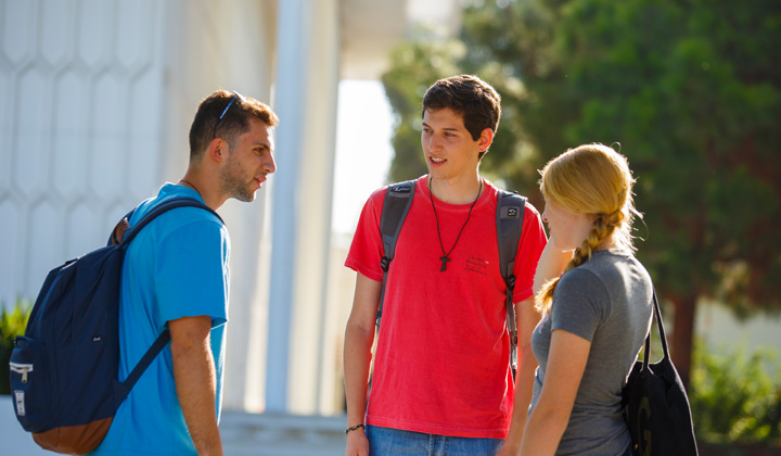 Students chat in front of Foley Pond