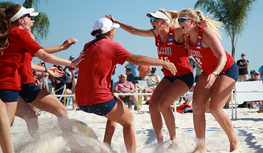 LMU women's beach volleyball players celebrate during their historic NCAA Tournament run in May 2021